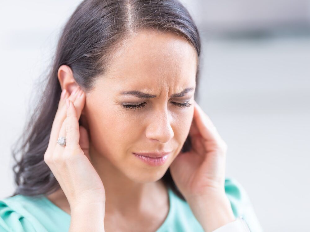 Patient describing ringing in the ears during a tinnitus evaluation at Advanced EARGEAR in Akron, OH
